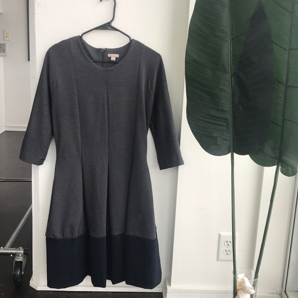 Dark grey A-line dress with navy blue trim.